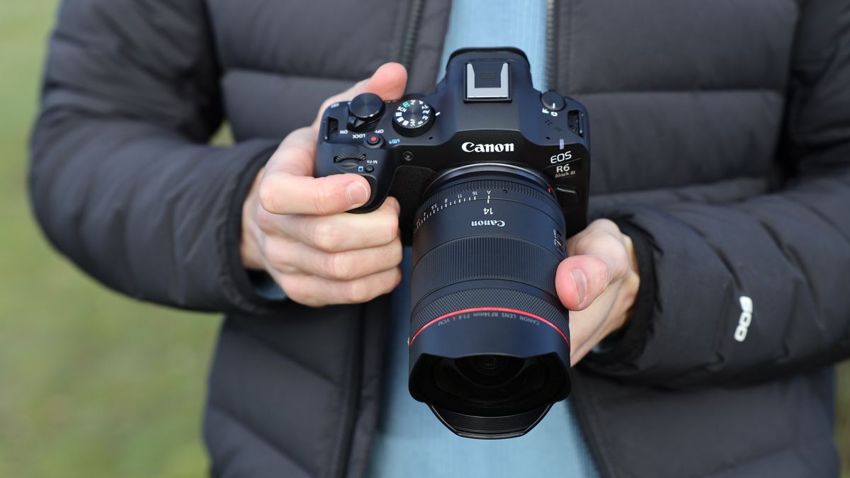 Canon EOS R6Mark III camera with Canon RF14mm f/1.4L VCM lens attached held in a pair of hands